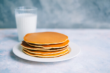 Tasty pancakes in a white plate on the table. copy space