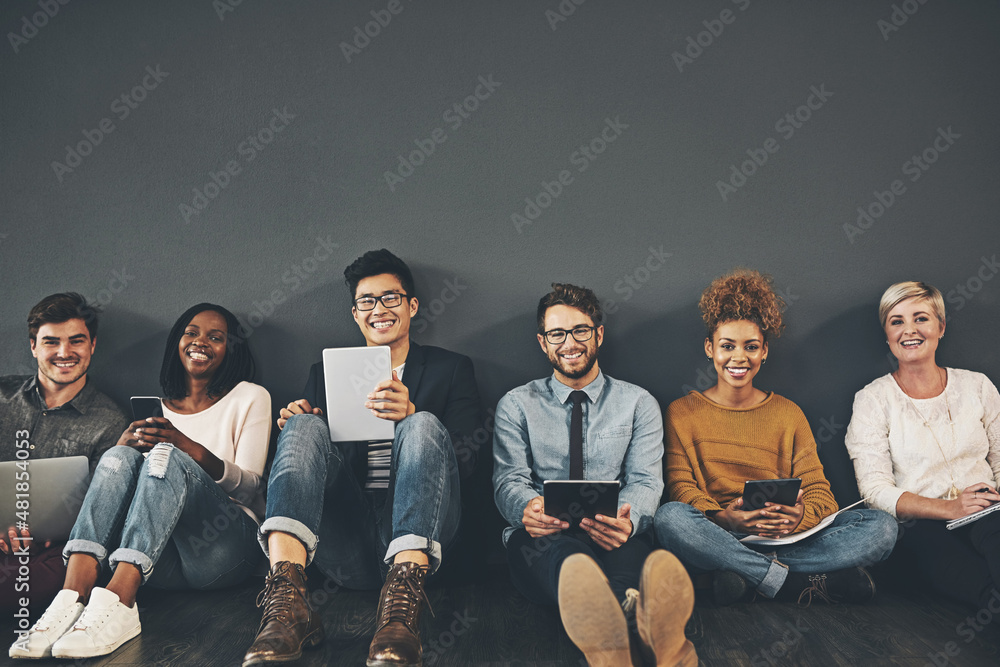 Aufkleber the technology team. studio shot of a diverse group of creative employees social networking against 