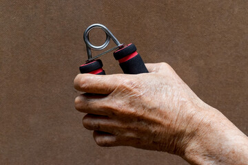Fototapeta premium Hand of Asian, Chinese old man gripping hand exercise gripper.