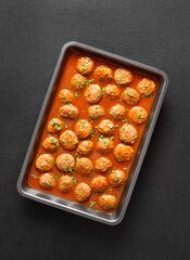 Meatballs with tomato sauce in baking dish