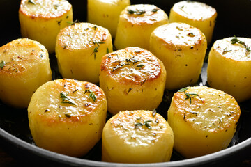 Fondant potatoes in frying pan