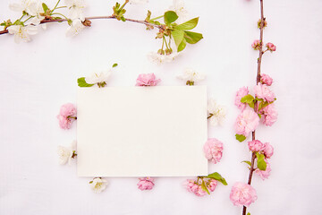 Feminine delicate stationery card mockup with spring white and pink flowers. Romantic, wedding, birthday, invitation, mother's day mock up card concept. Copy space. View from above