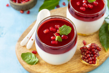Winter panna cotta with pomegranate jelly and mint, italian dessert, homemade cuisine.