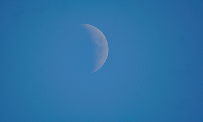 Half full moon and blue sky