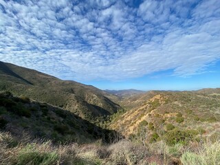 Fototapeta na wymiar Santa Monica Mountains, Point Mugu State Park, California, with small clouds in morning sky