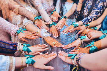 Girlfriends of the bride with henna on their hands. Arabic henna