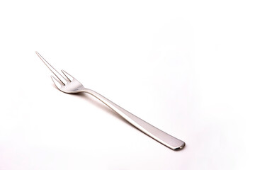 special stainless steel fork to eat mango fruit isolated on white background with space for text