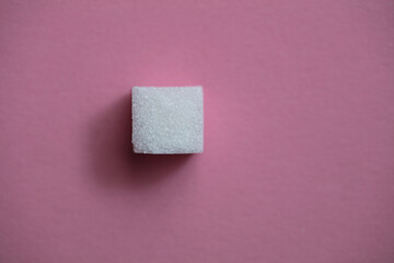 Sugar cubes on pink background
