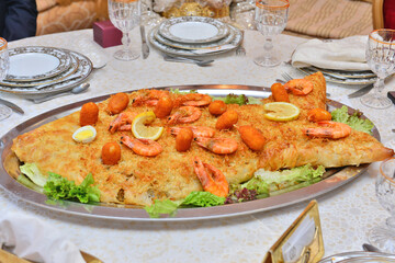Traditional whole fresh baked Moroccan fish pastilla close up.