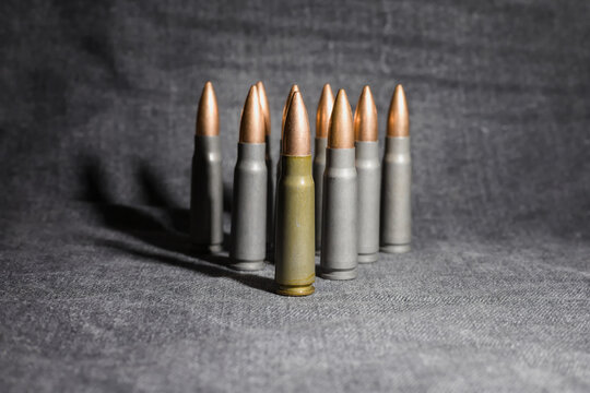 7,62x39 cartridges, triangle formation, gray denim background