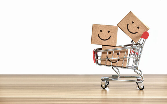product box with smile icon on shopping cart,happy shopping concepts on white background and copy space.