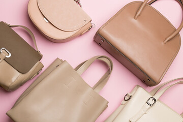 Fashionable woman bag on wooden background. Top view