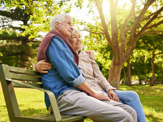 Fototapeta premium Retired in comfort and happiness. Shot of a happy senior couple relaxing on a park bench.