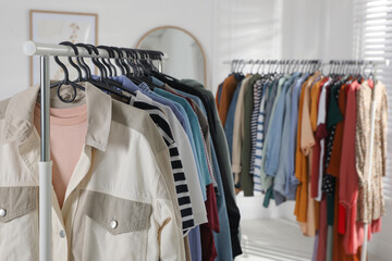Obraz premium Racks with stylish clothes indoors. Fast fashion