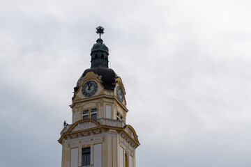 Fototapeta na wymiar Clock tower with beautiful ornamental facade, detail from city assembly building in city of Pecs, Hungary