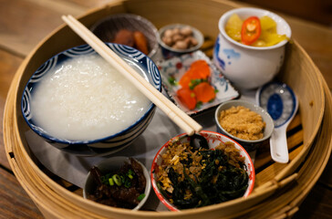Chinese porridge served with various side dishes