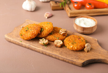 Board with tasty lentil cutlets on color background