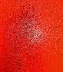 Beautiful, bright, unusual background created by abstract patterns, formed by multi-colored lighting of the embossed glass surface