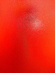 Beautiful, bright, unusual background created by abstract patterns, formed by multi-colored lighting of the embossed glass surface