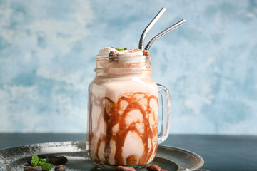 Mason jar of sweet cocoa drink on table