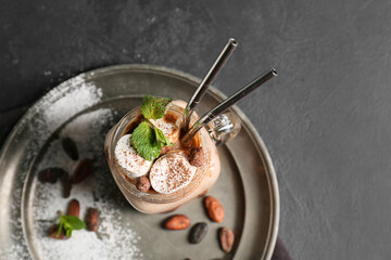 Mason jar of sweet cocoa drink on dark background