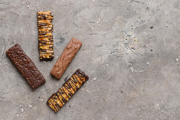 Tasty chocolate nut bars on grunge background