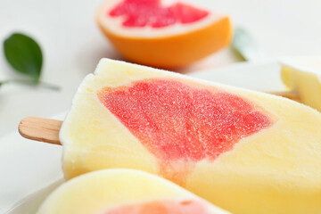 Fototapeta na wymiar Plate with tasty grapefruit ice cream, closeup