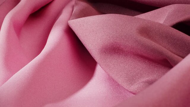 Pink fabric close-up, satin luxury cloth texture background. Luxurious design textile. 