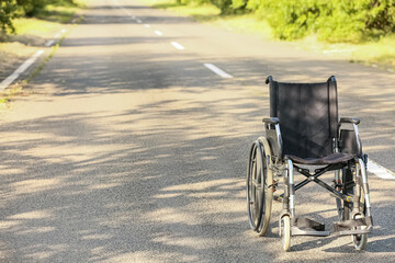 Fototapeta na wymiar Empty modern wheelchair on road outdoors