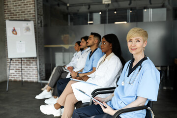 Blonde middle-aged woman doctor attending medical conference