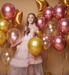 Beautiful girl smiling with balloons