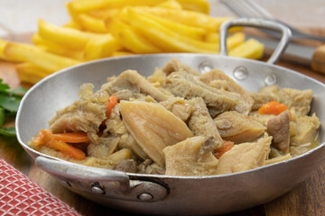 dish of tripe and fries on a table	