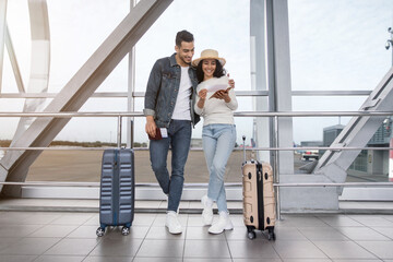 Waiting For Flight. Happy Arab Couple Standing At Airport Terminal With Suitcases