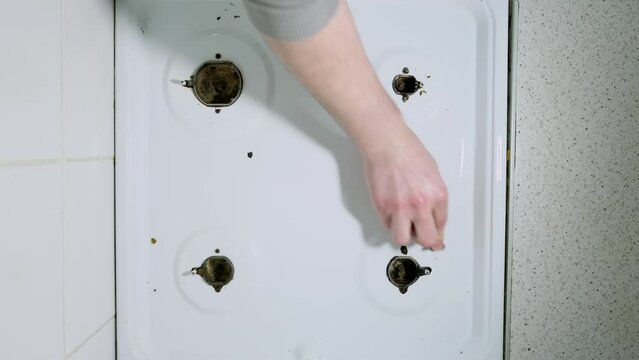 Top view footage of cleaning gas stove at home.