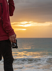 Closeup of mirrorless camera in a beautiful sunset evening