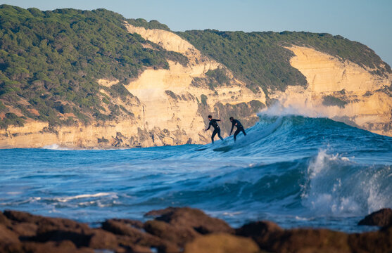 Surfers riding waves in Los Ca&ntilde;os de Meca, South Spain