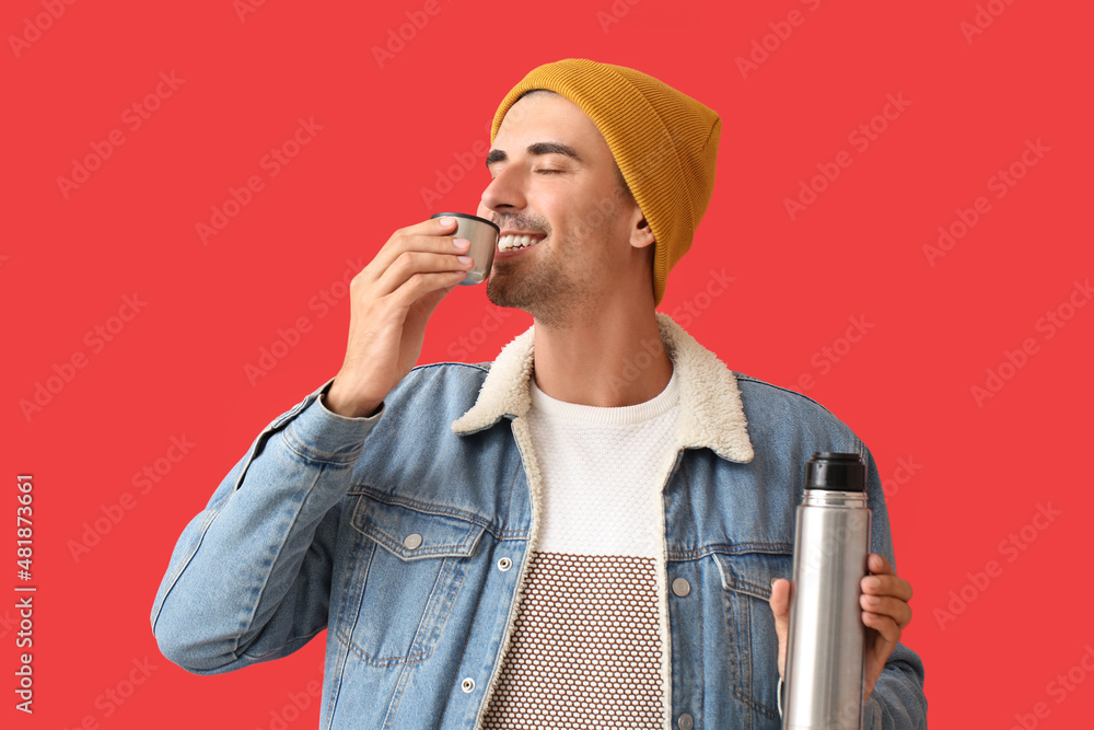 Sticker Handsome man with thermos on color background