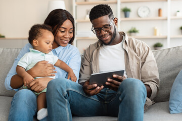Portrait of african american family using tablet at home