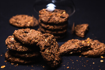 Chocolate chip cookies with chocolate chips on a black background. Sweet chocolate treat. homemade cookies
