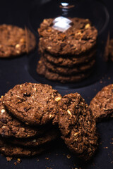 Chocolate chip cookies with chocolate chips on a black background. Sweet chocolate treat. homemade cookies