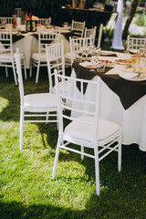 A summer tent with tables, food  and chairs on the wedding day