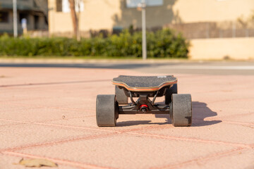 Front view of electric skateboard or longboard on city street, selective focus