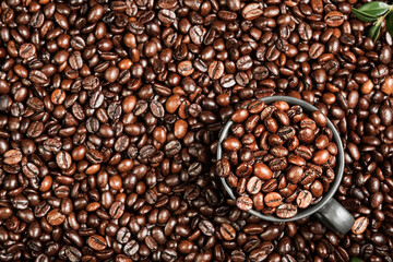Coffee background with space for text, layout of coffee beans on the table and black cup for espresso coffee, coffee advertising idea