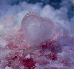 A piece of ice in the shape of a heart. Valentine's Day. The concept of love, romance.