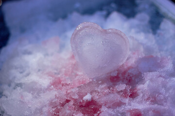 A piece of ice in the shape of a heart. Valentine's Day. The concept of love, romance.