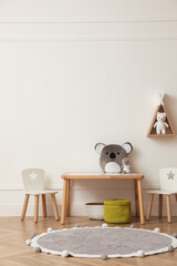 Cute child room interior with furniture, toys and wigwam shaped shelf on white wall © New Africa
