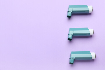 Asthma inhalers on color background