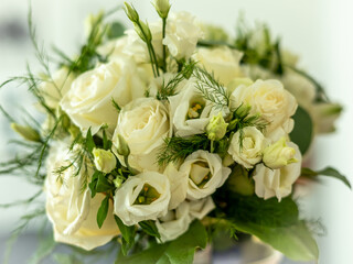 A bridal wedding flower bouquet with white eustomas and roses. 