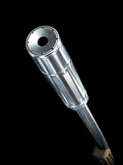 Suppressor on a rifle barrel on a dark background