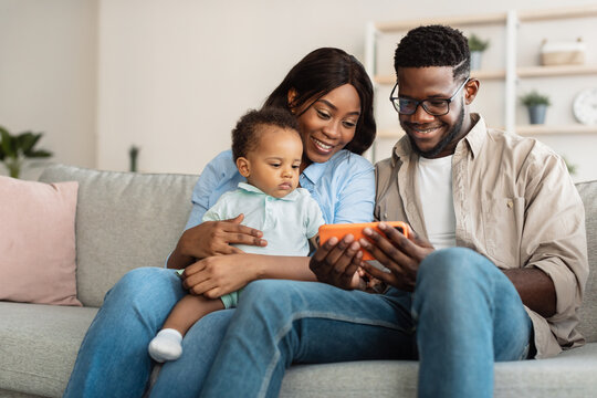 Portrait of african american family using cellphone at home